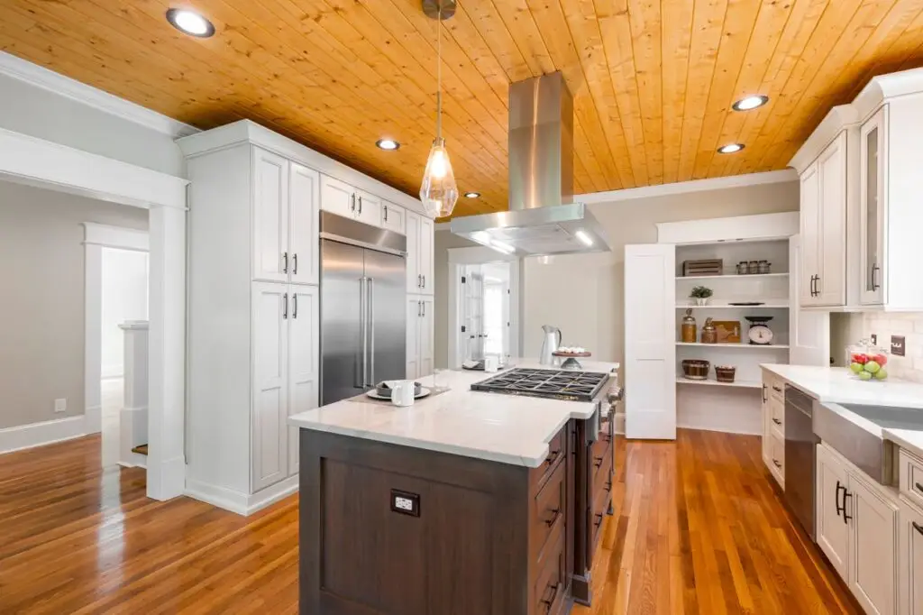 Spacious kitchen with wood accents, stainless appliances, and central island. Kuna-ID