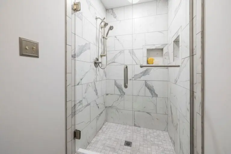 Elegant bathroom with white marble tiles and glass door, showcasing interior design. installed in Eagle ID